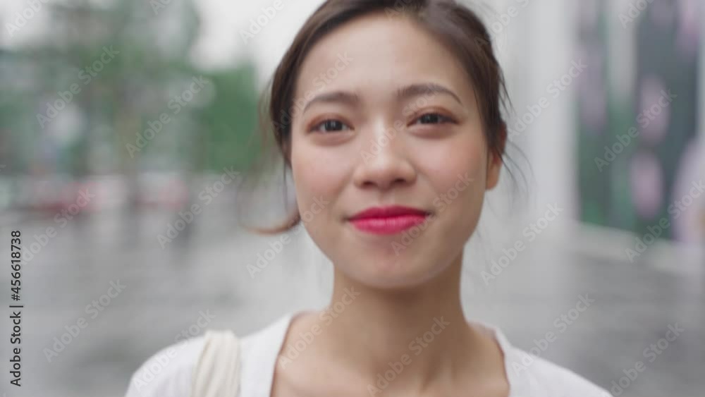4k clip happy beautiful young asian woman walking in the urban city street looking at camera smile 4k clip happy beautiful young asian woman walking in the urban city street looking at camera smile