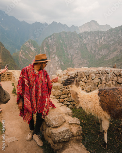 Man in hat in Peru with a Alpaca photo