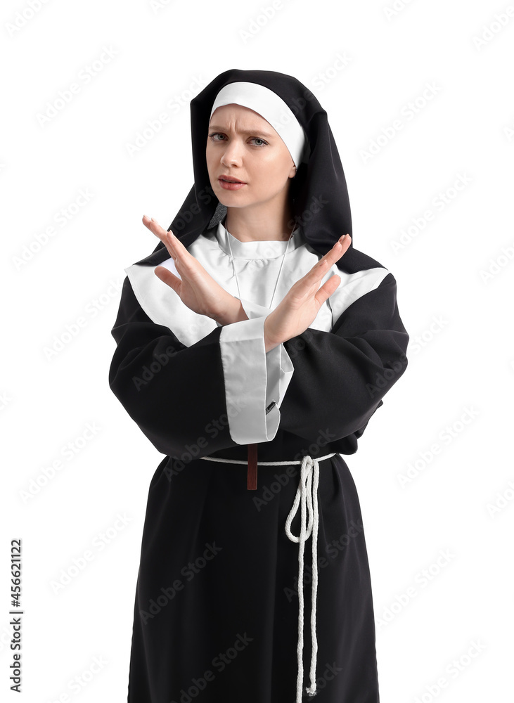 Young nun showing STOP gesture on white background Young nun showing STOP gesture on white background