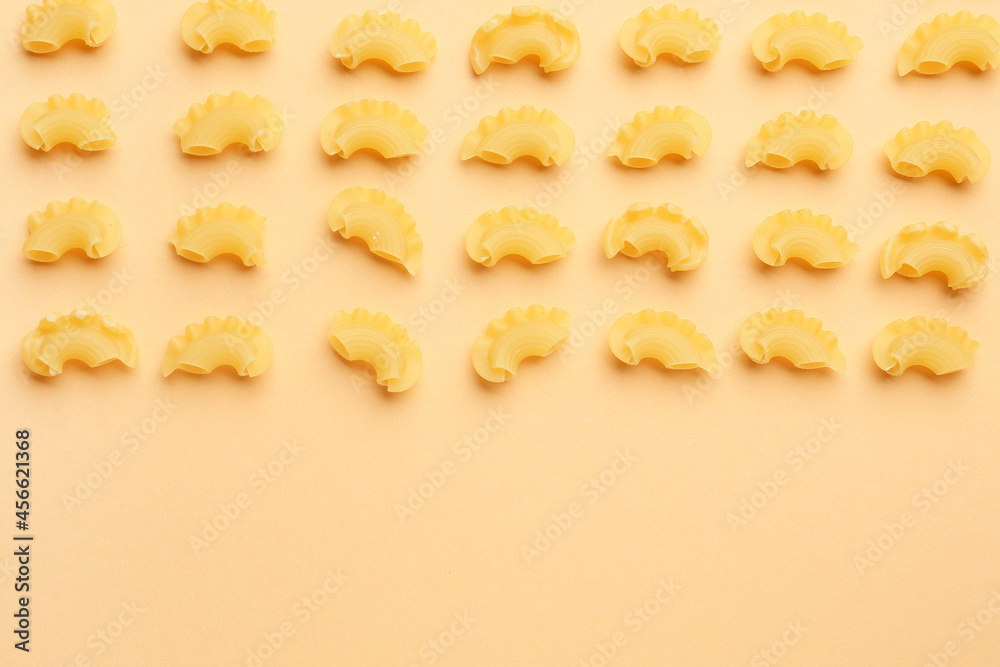 Uncooked creste pasta on color background