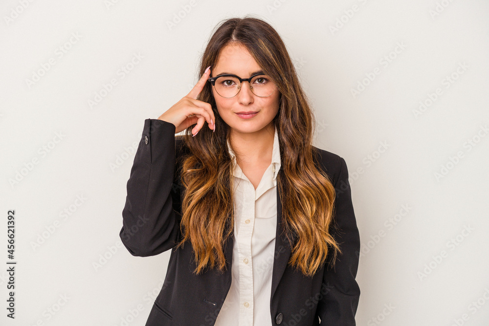 Young caucasian business woman isolated on white background pointing temple with finger, thinking, focused on a task. Young caucasian business woman isolated on white background pointing temple with finger, thinking, focused on a task.