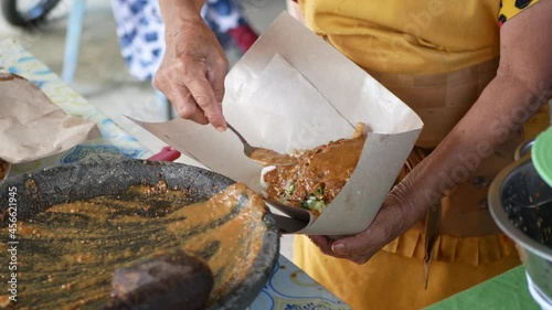 An Indonesian old woman is preparing 