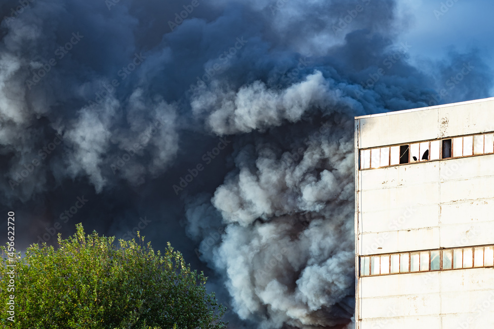 Smoke from fire. Fire in factory or enterprise. Puffs of black smoke