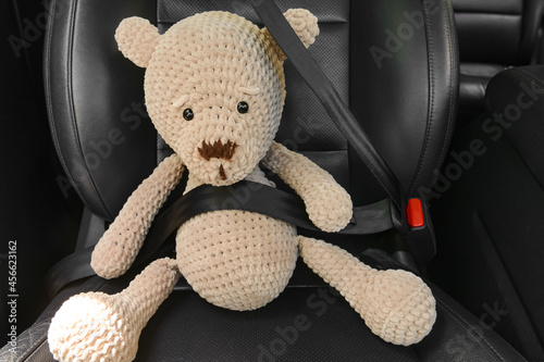 Fastened toy teddy bear sit...