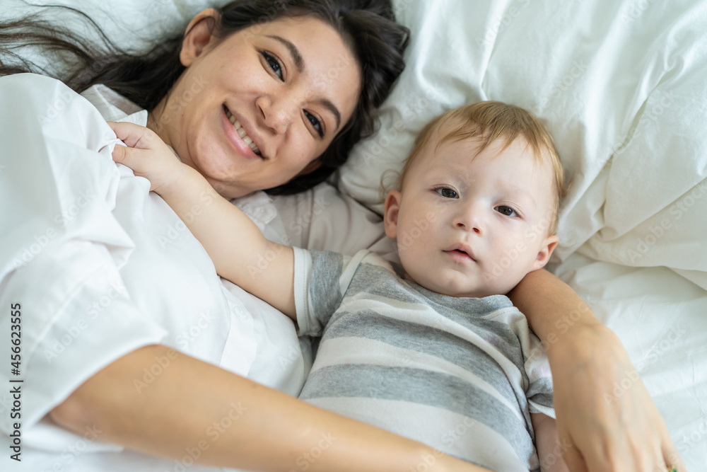 Portrait of Caucasian happy family smiling, look at camera in bedroom. Portrait of Caucasian happy family smiling, look at camera in bedroom.