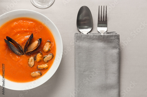 Bowl of tasty Cacciucco soup on table, closeup photo