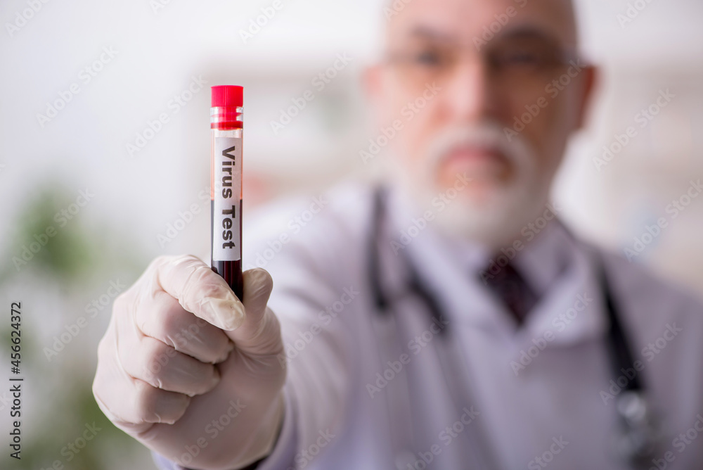 Old male doctor hematologist working in the clinic Old male doctor hematologist working in the clinic