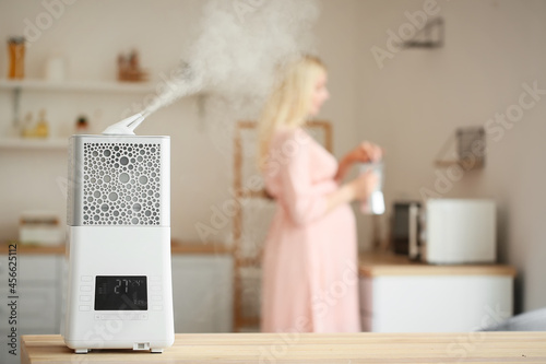 Modern humidifier at table ...