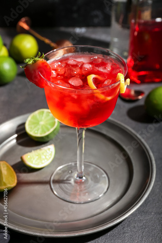 Glass of tasty cosmopolitan cocktail on dark background © Pixel-Shot