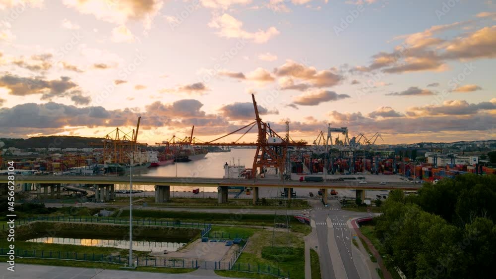 Dramatic Sunset Sky Over Port Of Gdynia With Trucks Passing By On The Road In Poland. Aerial Dramatic Sunset Sky Over Port Of Gdynia With Trucks Passing By On The Road In Poland. Aerial