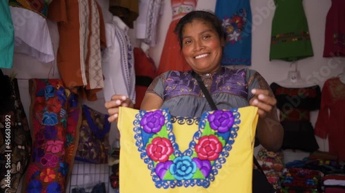 Mexican smiling at camera, mother working in regional clothing business, Chiapas, México photo