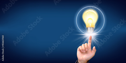 Idea innovation and inspiration concept. businessman holding illuminated light bulb