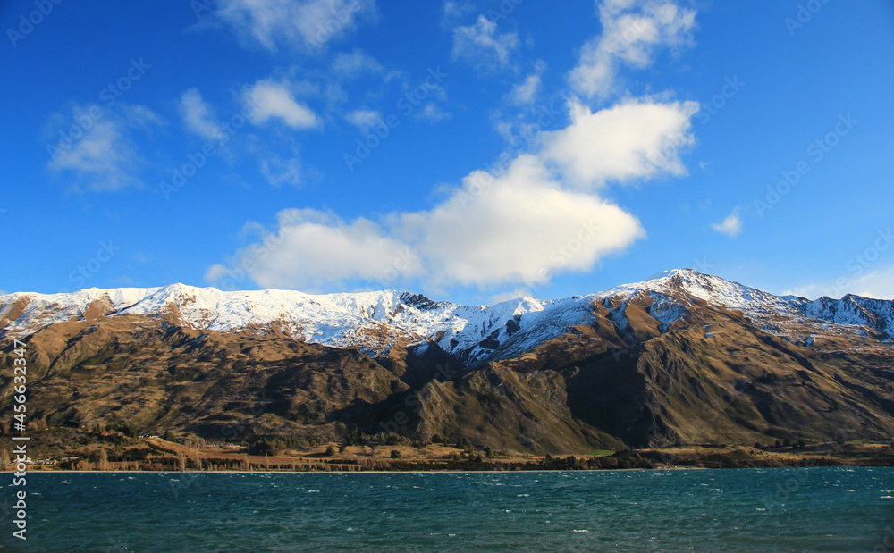 Amazing landscape with mountains, snow, trees and blue sky. The view are around Wanaka in south island of New Zealand.