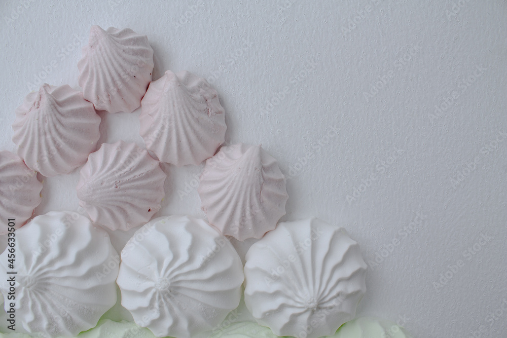 Marshmallows of different sizes, pink and white. White background Marshmallows of different sizes, pink and white. White background