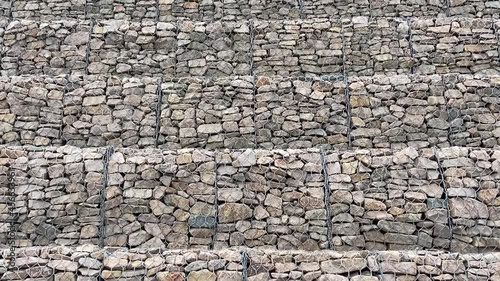 Gabion wall constructed using steel wire mesh basket. Stone walls, protection from backshore erosion. Gabion and rock armour-coastal and waterways protection photo