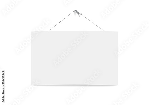 Blank white board hanging on string on metal straight nail hammered in wall.
