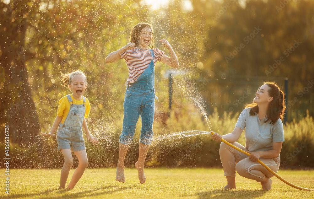 Fototapeta premium Happy family playing in backyard