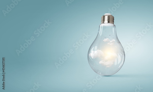 Light bulb on light blue background © Sergey Nivens