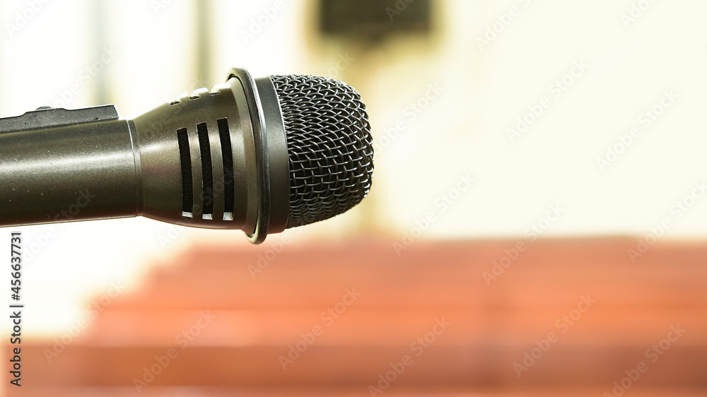 Fototapeta premium close up of microphone over blurred background.
