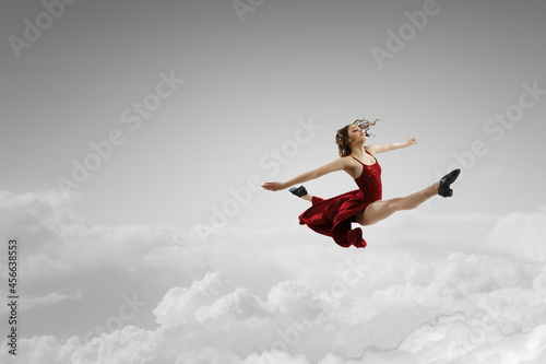 Female dancer against sky b...