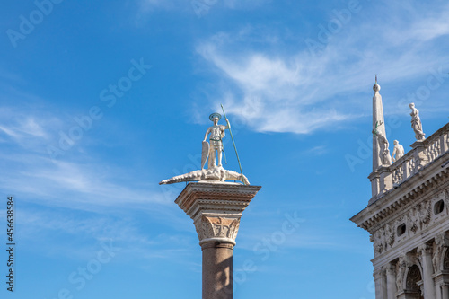 Sculpture of Sacred Teodor - the first patron of Venice standing on a dragon won by it. It is established at column top on Piazza San Marco, Venice photo