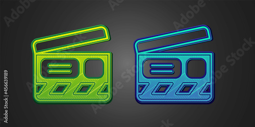 Green and blue Movie clapper icon isolated on black background. Film clapper board. Clapperboard sign. Cinema production or media industry. Vector