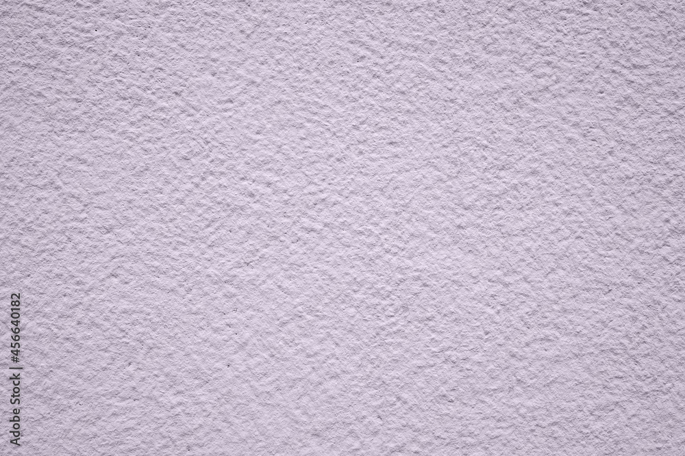 Concrete wall close up. Lilac painted cement grainy textured background.