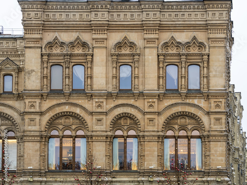 Fragment of the facade of a building with windows of the 19th century in the classicism style.