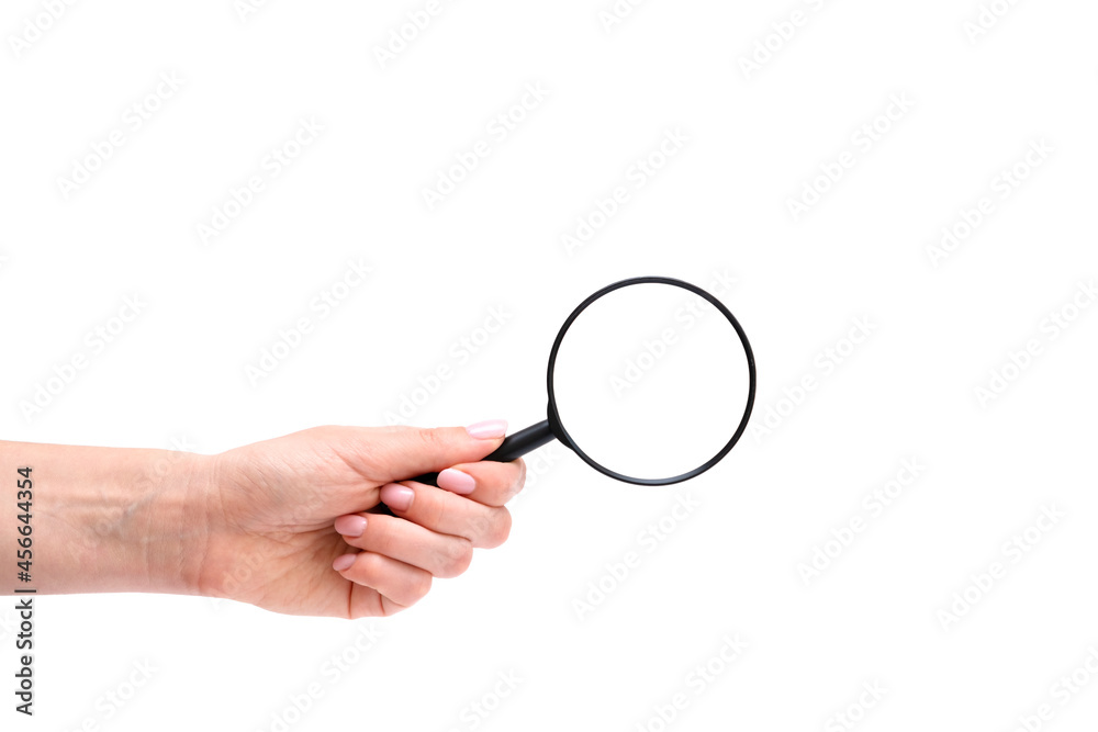 Woman's hand, holding magnifying glass, closeup isolated on white background, copy space for your image or text Woman's hand, holding magnifying glass, closeup isolated on white background, copy space for your image or text