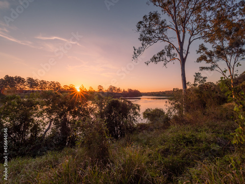 Sunset Over a River with Golden Light and Sunstar