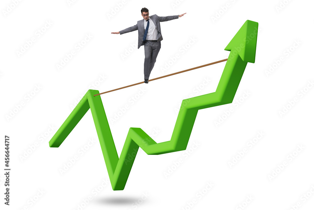 Businessman balancing on tightrope on line chart Businessman balancing on tightrope on line chart