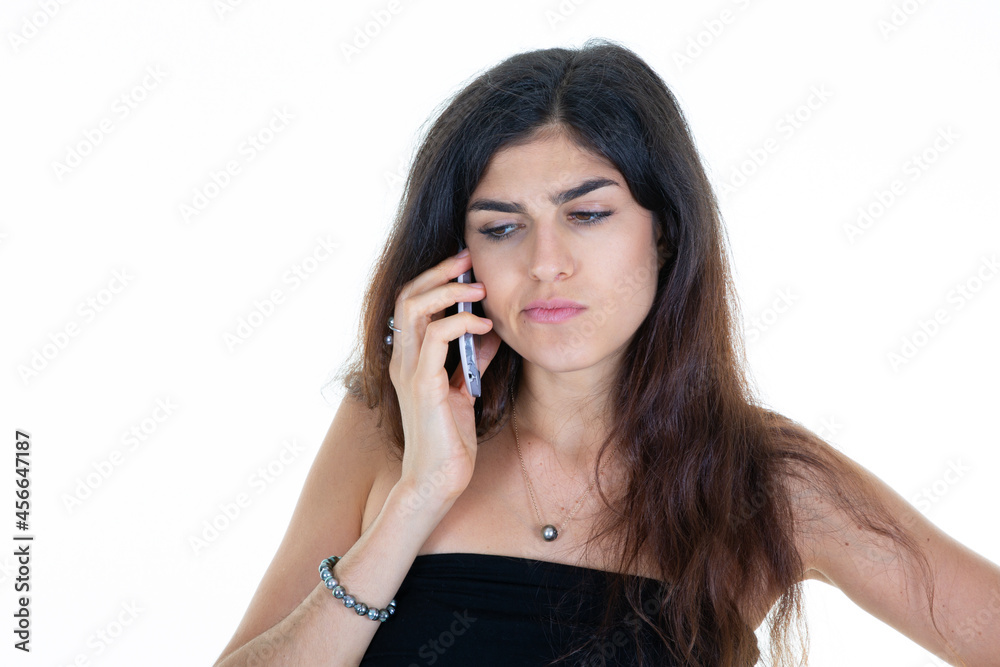 portrait of young sad frustrated woman talking on the phone portrait of young sad frustrated woman talking on the phone