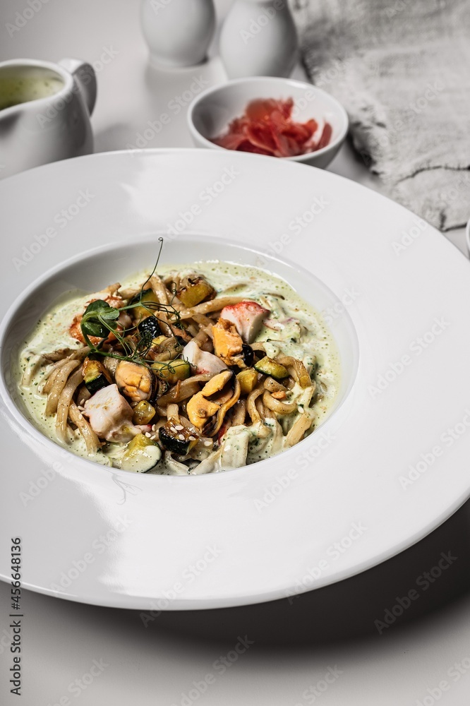 Close-up spaghetti with seafood. Traditional Italian pasta with shrimps, mussels and squid with a spicy sauce. Mediterranean Kitchen. Vertical shot Close-up spaghetti with seafood. Traditional Italian pasta with shrimps, mussels and squid with a spicy sauce. Mediterranean Kitchen. Vertical shot