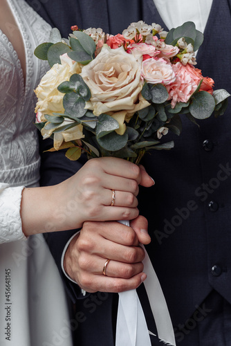hands of young people with wedding wedding rings. wedding day details. calla flowers. spouses newlyweds groom and bride