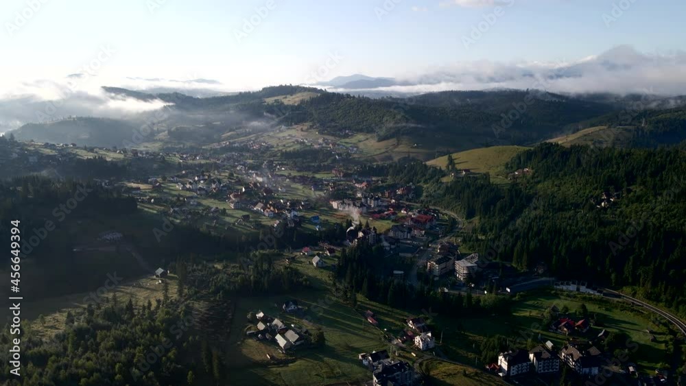 aerial view of sunrise above mountains village aerial view of sunrise above mountains village