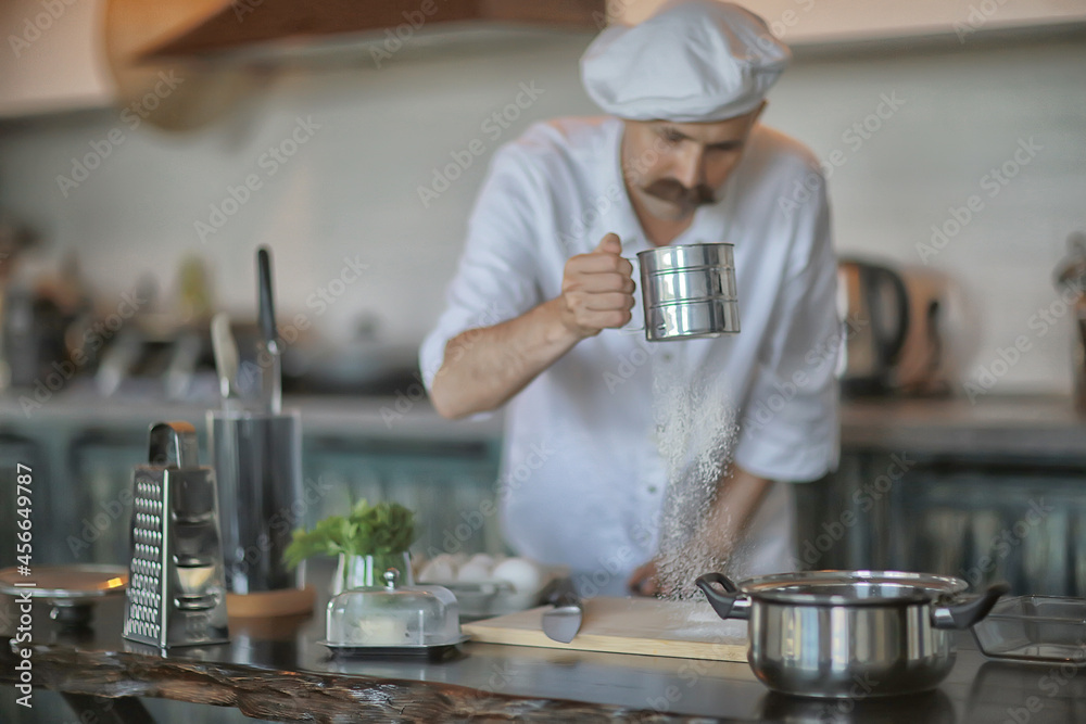 french chef in the kitchen preparing food, cooking, haute cuisine, man with mustache