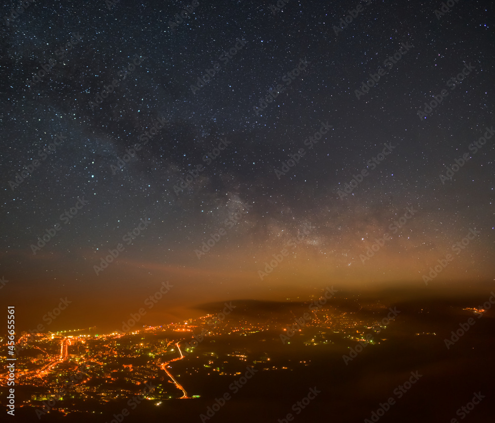view from above to night city under starry sky