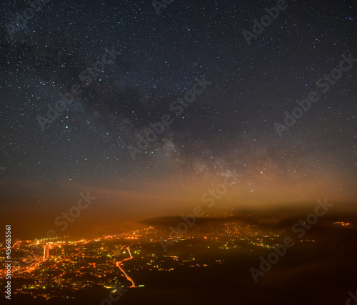 view from above to night city under starry sky