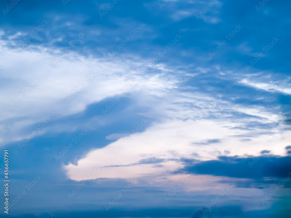 Low Angle. In the morning sky, a blue crocodile-shaped cloud is grabbing prey. During the rainy season, Thailand. 