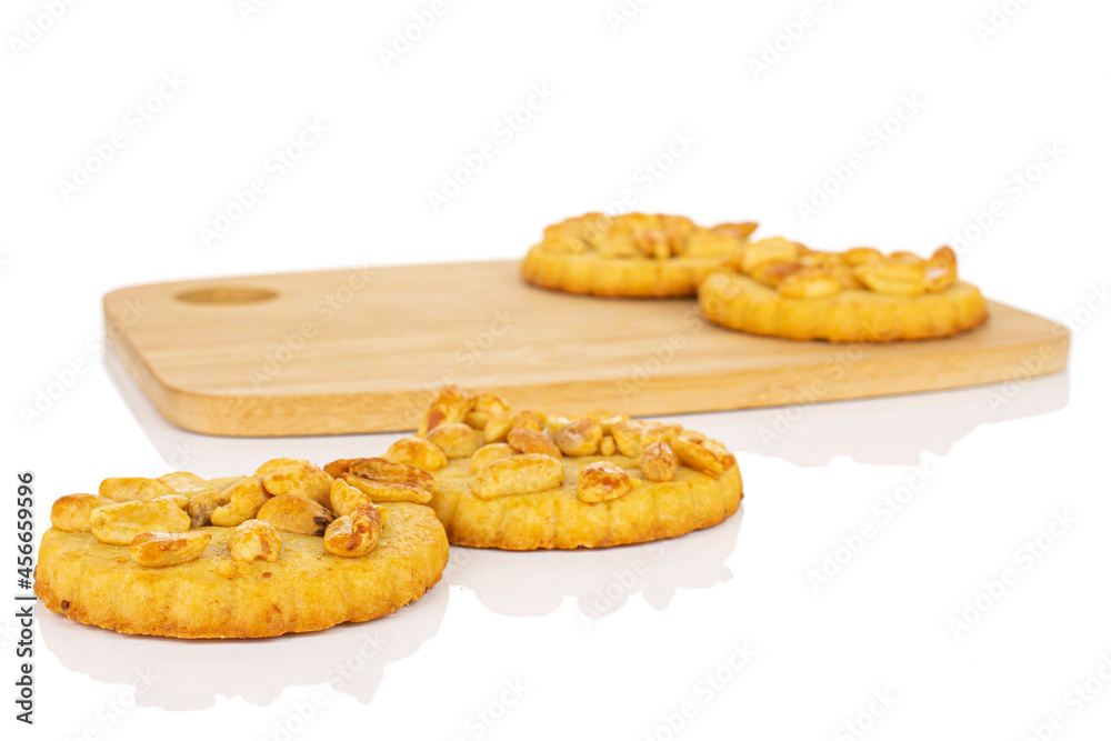 Group of four whole delicious cookie with peanuts on bamboo cutting board on white background Group of four whole delicious cookie with peanuts on bamboo cutting board on white background