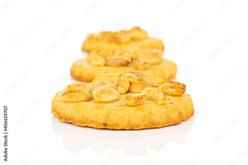 Group of three whole delicious cookie with peanuts in row on white background