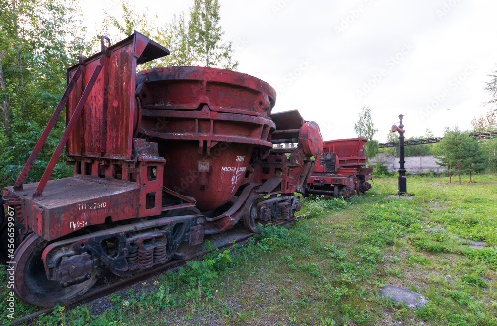 Fototapeta premium red trolley with a container on rails