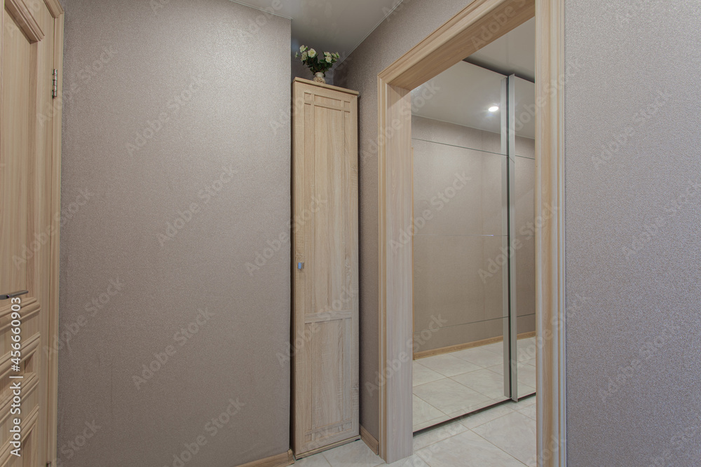 Luxurious interior of the hallway with a mirror and a bouquet of flowers Luxurious interior of the hallway with a mirror and a bouquet of flowers