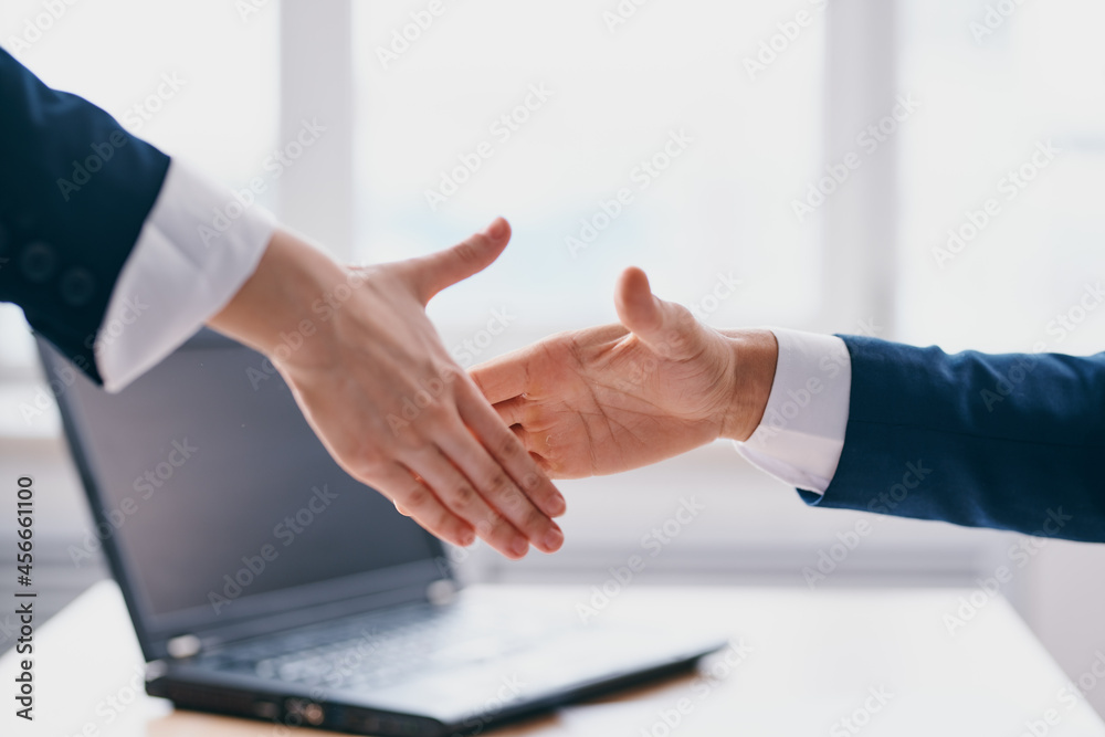 colleagues shaking hands successful deal office laptop professionals