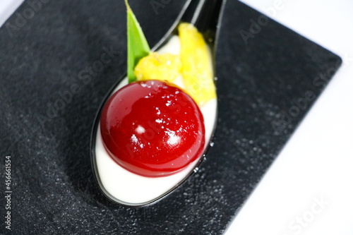 luxury hand made Micheline French modern red panna cotta dessert on white black background photo