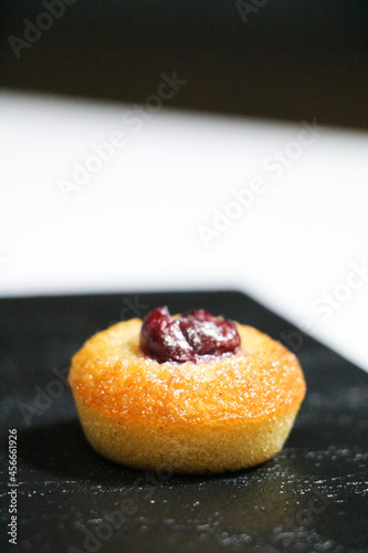 luxury hand made Micheline French modern financier with plum dessert on white black background photo