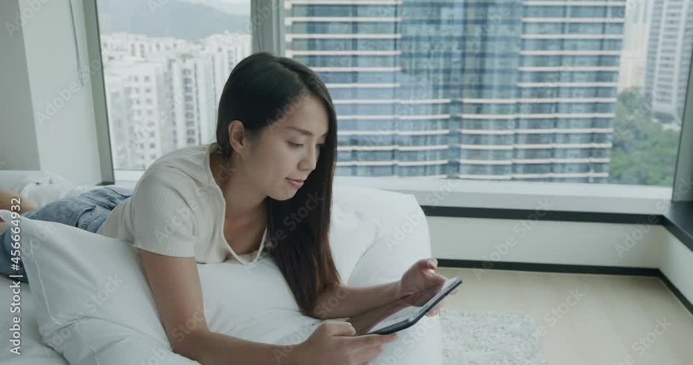Woman lying on bed and use of tablet computer Woman lying on bed and use of tablet computer