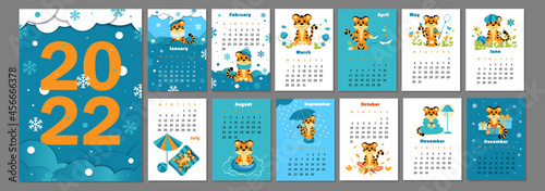 Vector vertical calendar 2022 with symbol of the year tiger. Cute funny character little tiger in cartoon and paper cut style. Week starts in Monday. A set of 12 peges and cjver in size A3, A4, A5.