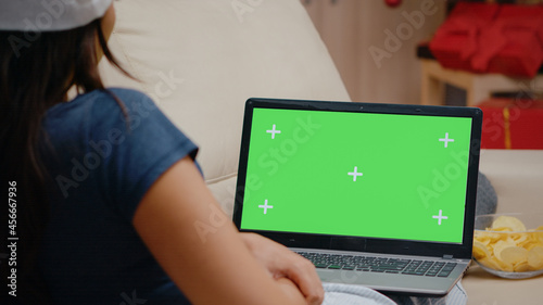 Close up of person watching horizontal green screen on laptop. Woman looking at chroma key on modern device with isolated background and mockup template. Adult with gadget screen