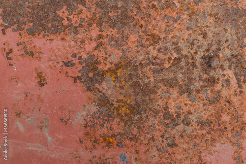 Surface of rusty iron with remnants of old paint, magenta,red texture, background.